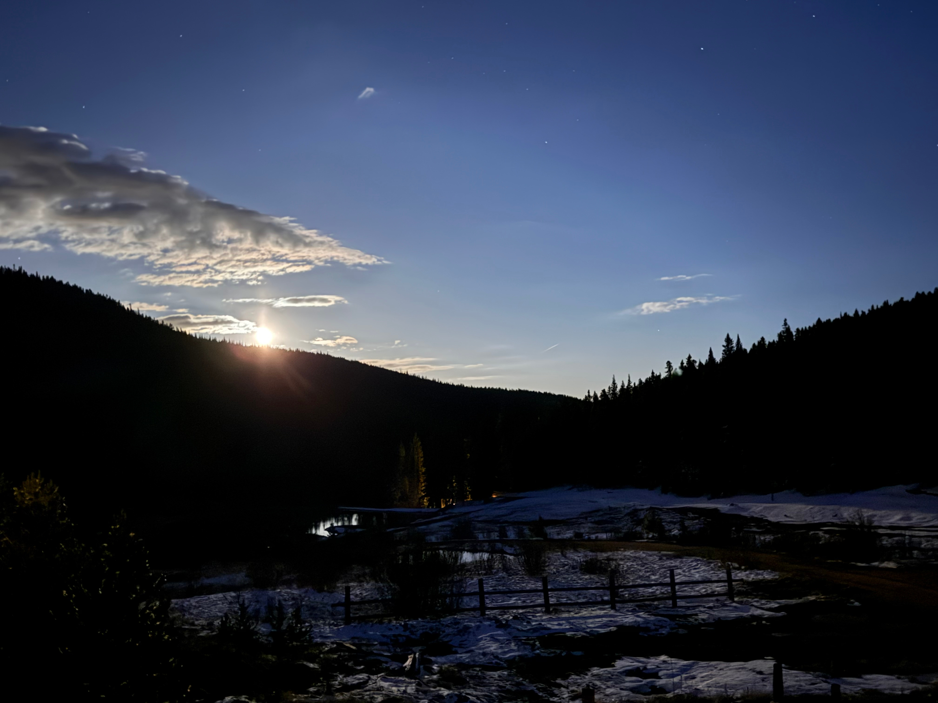 Mountain valley at dusk with the moon rising